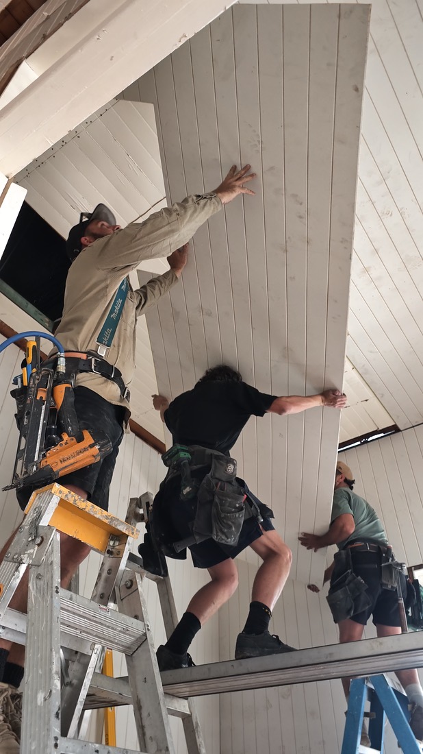 Frame from a clip: three of the crew on ladders