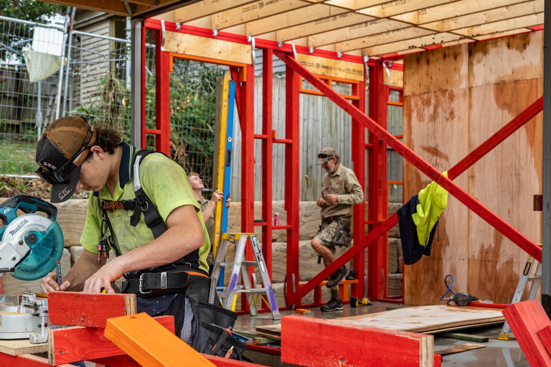 The crew at work inside the new red timber frame
